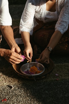 Volunteers arranging fresh flowers and cleaning the temple courtyard.