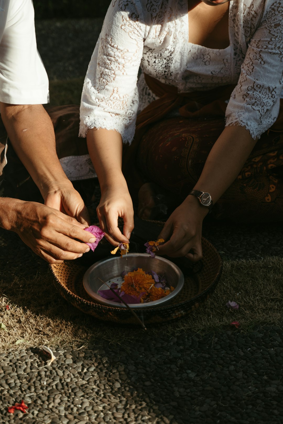 person in white shirt holding round plate with food