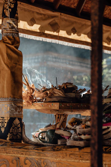 Luxurious Cambodian oud wood pieces arranged artistically with warm amber light casting shadows.
