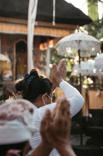 woman in white long sleeve shirt holding hands with woman in white long sleeve shirt