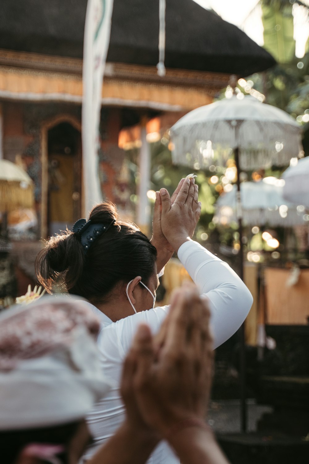 woman in white long sleeve shirt holding hands with woman in white long sleeve shirt