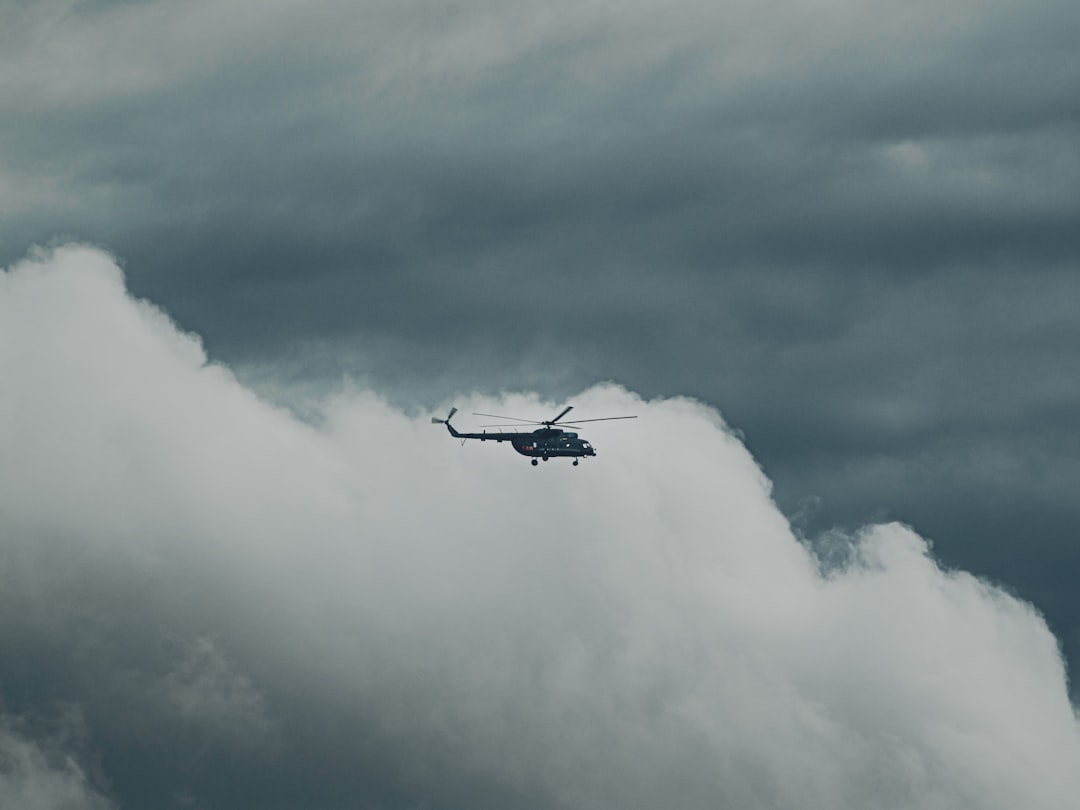 black airplane flying on sky during daytime