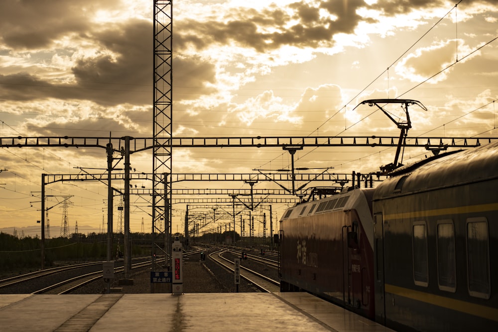 yellow train on rail under cloudy sky