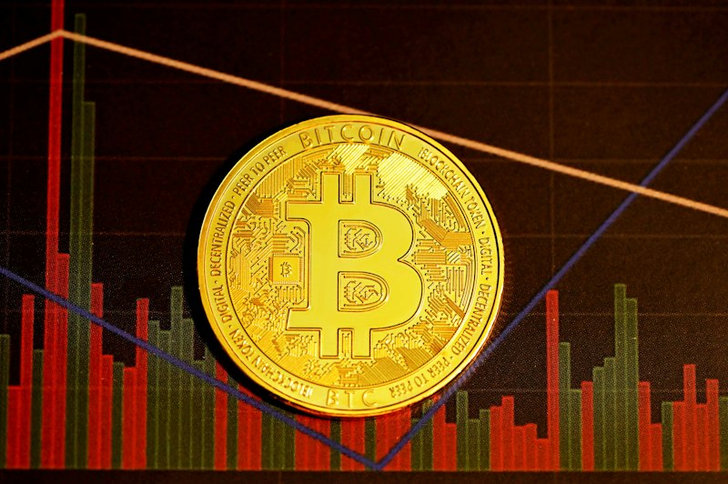 gold round coin on red and black textile