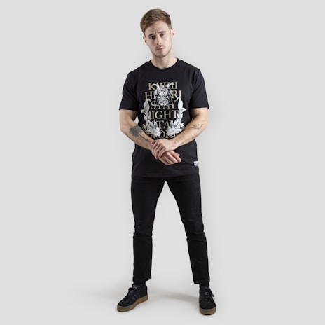 Model wearing a minimalist anime print tee with a sleek black background.