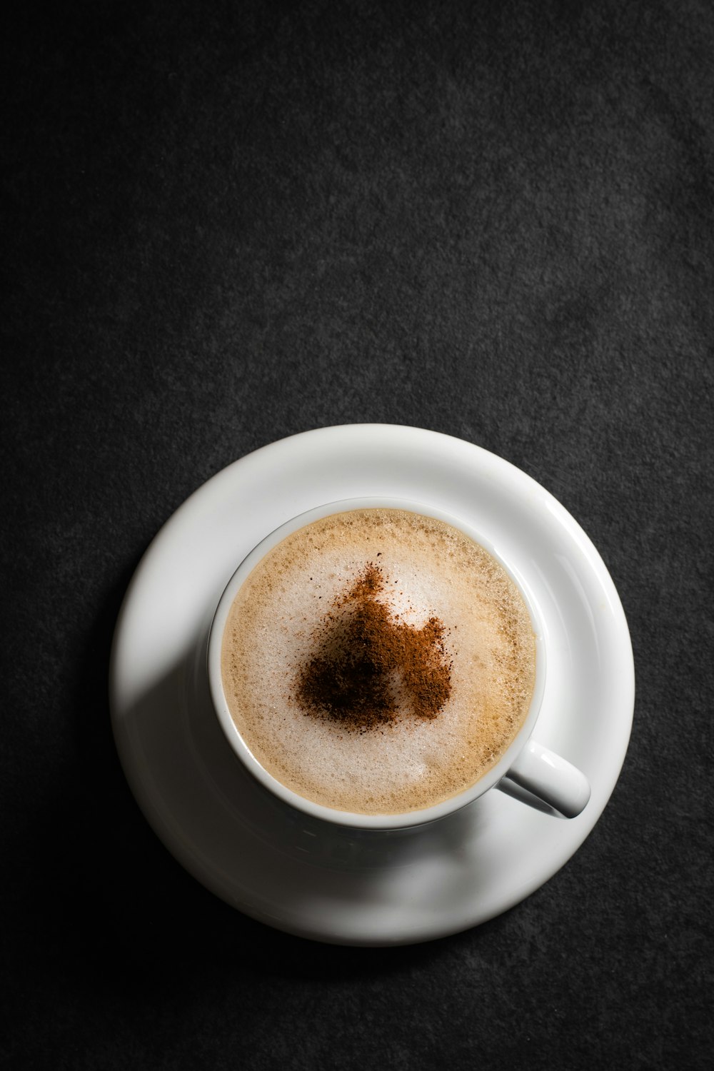 white ceramic mug with brown liquid