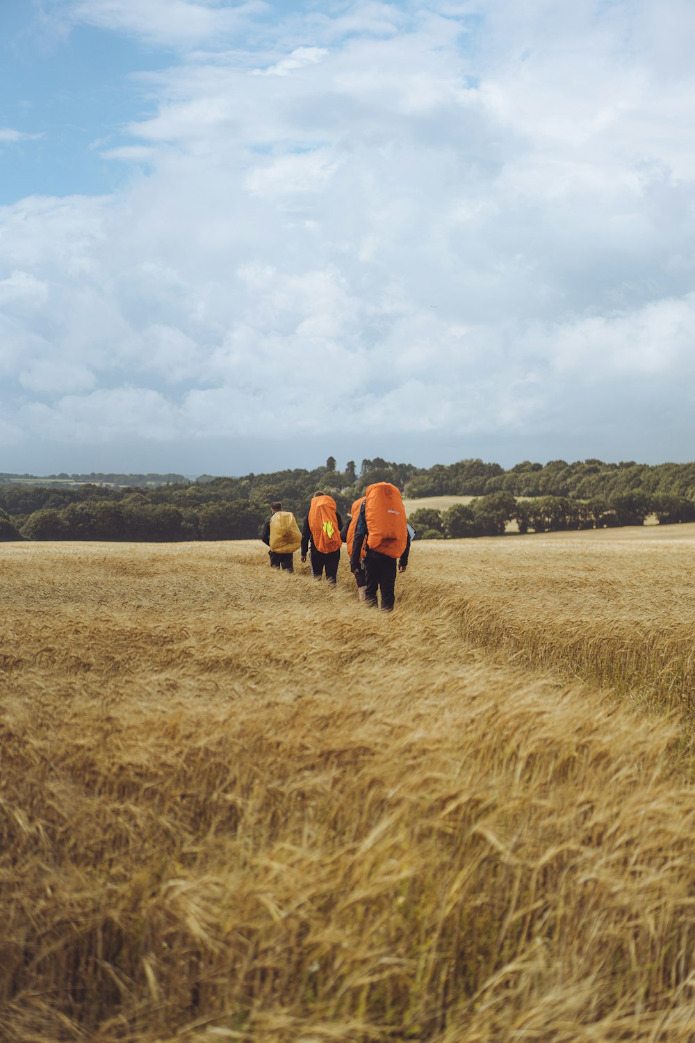 2 person in brown coat standing on brown grass field during daytime