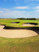 Golfers enjoying a sunny afternoon on the well-manicured course.