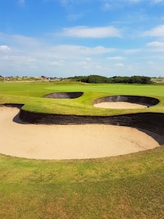 Golfers enjoying a sunny day on a lush outback golf course.