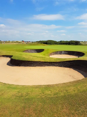 Golfers enjoying a sunny afternoon on the well-manicured course.