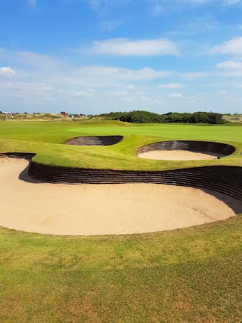 Golfers enjoying a sunny day on a lush outback golf course.