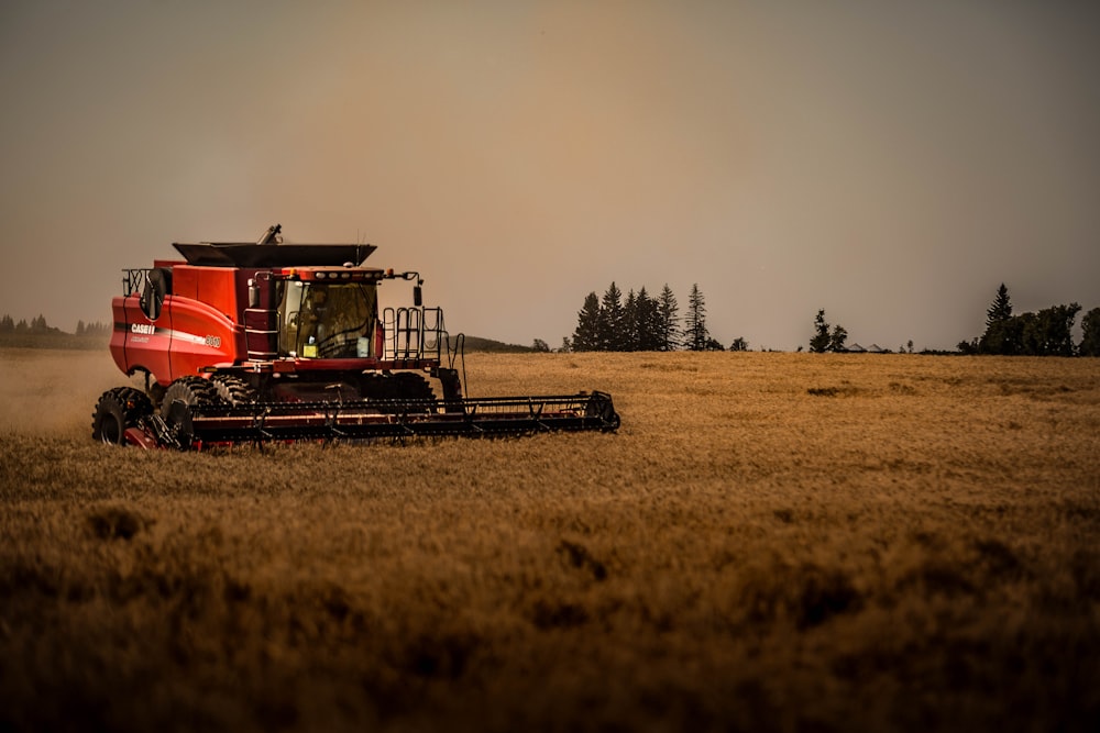 red and black train on brown field during daytime