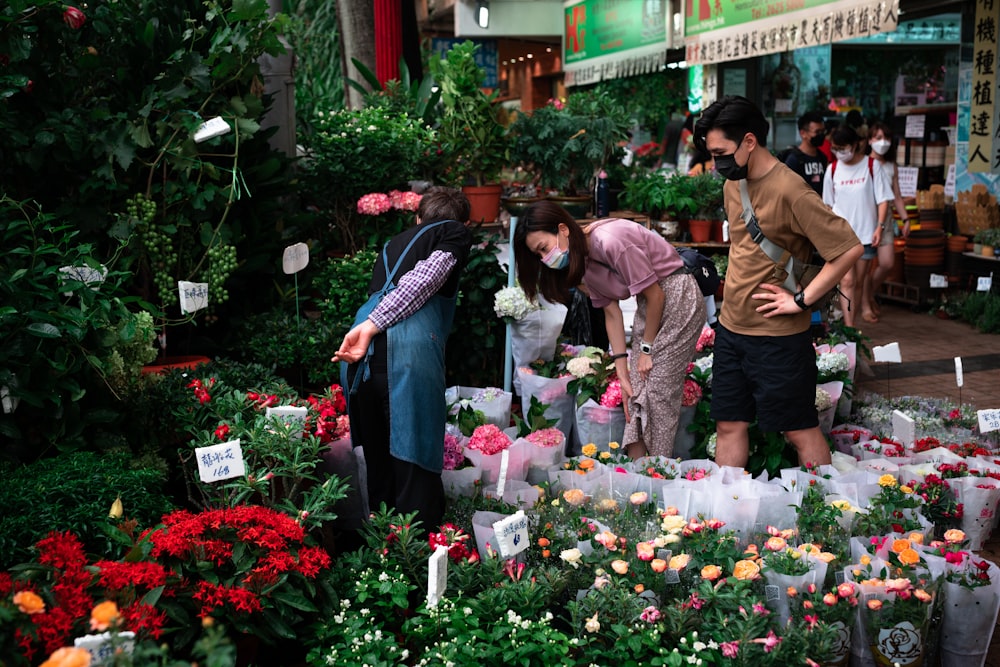 people standing in front of flowers