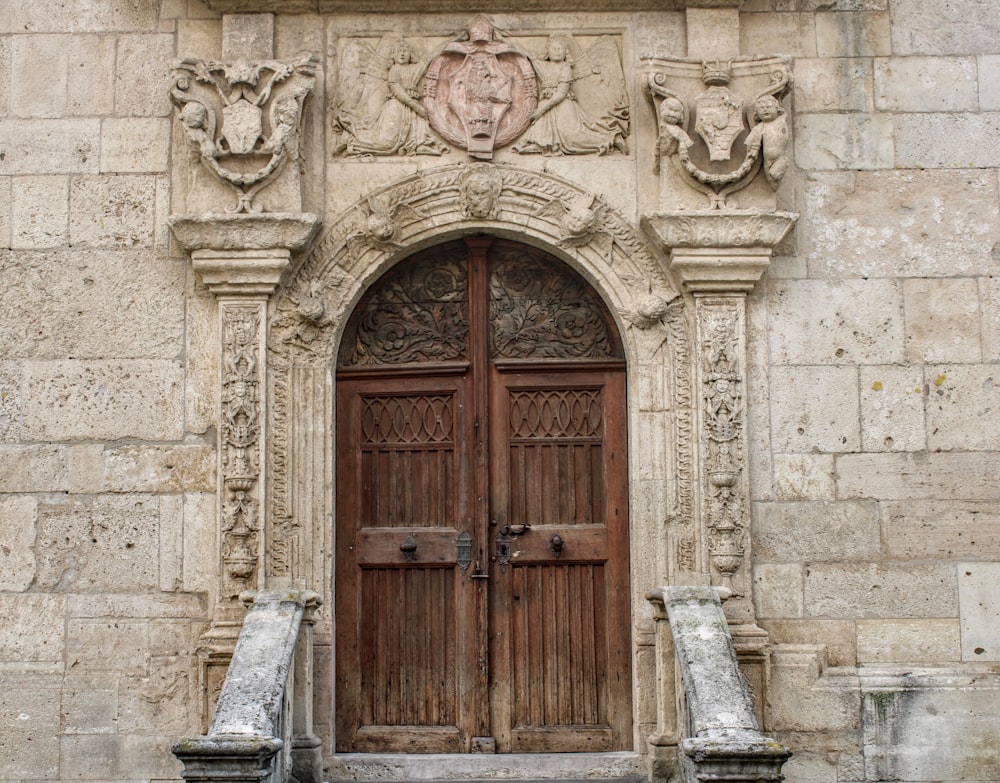 brown wooden door on gray concrete building