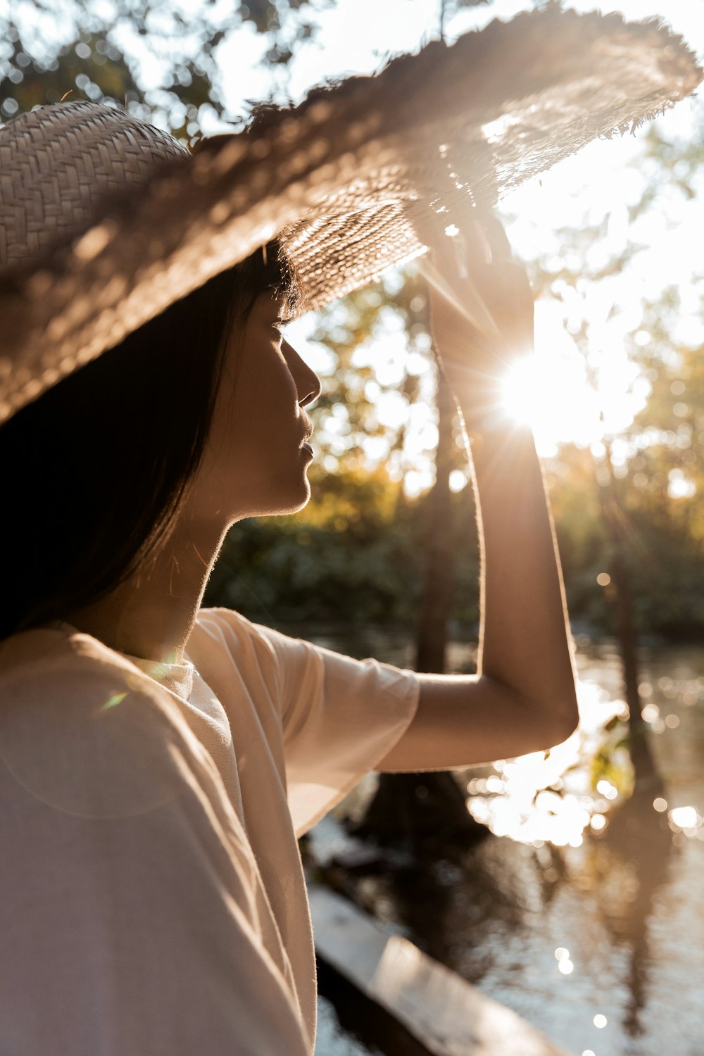 woman in white shirt and black hat