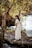 woman in white dress standing near body of water during daytime