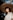 woman in white shirt wearing brown straw hat