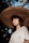 woman in white shirt wearing brown straw hat