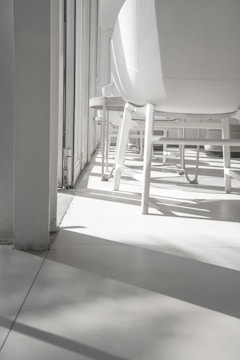 Minimalist salon furniture set in a clean, white room with natural light.