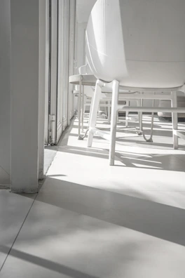 Elegant dining area bathed in natural light, showcasing minimalistic design and soft shadows.