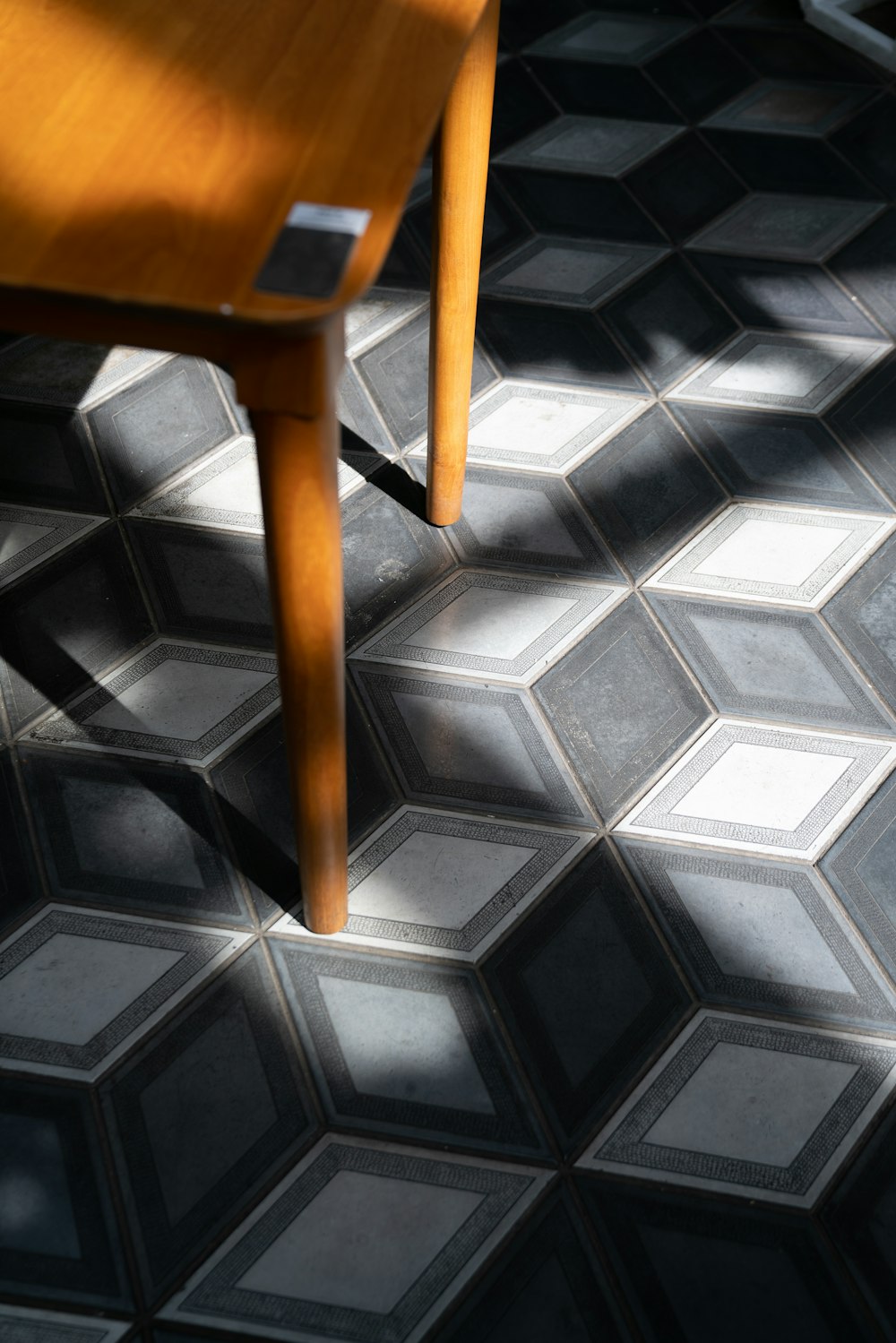 brown wooden table on white and black floor tiles