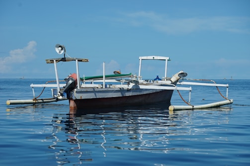 Yamaha outboard motor mounted on a fishing boat cutting through calm blue waters