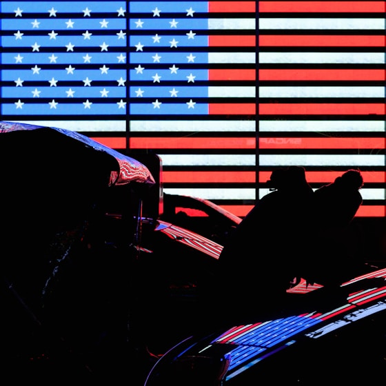 man in black jacket sitting on red chair