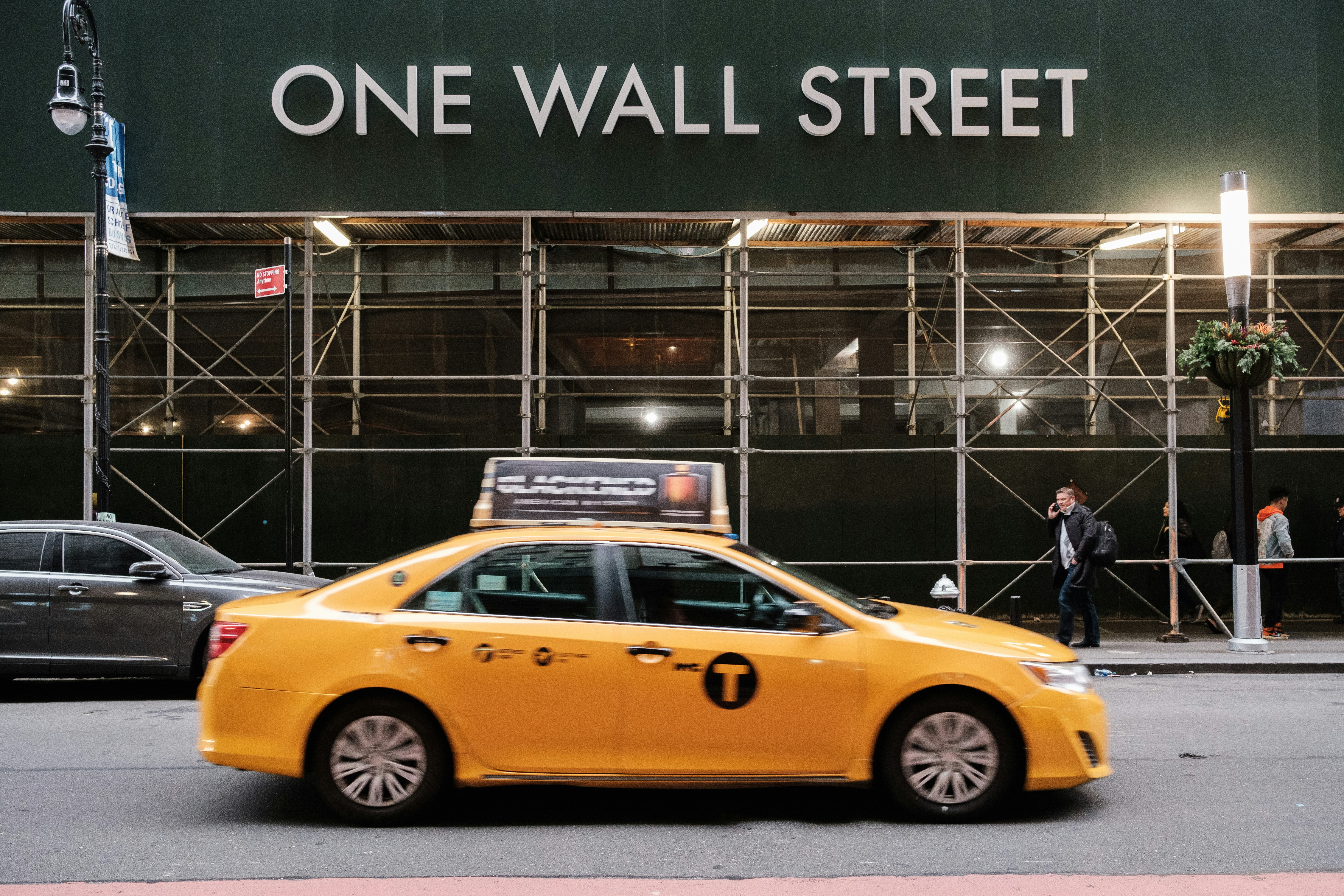 yellow taxi cab in front of the building