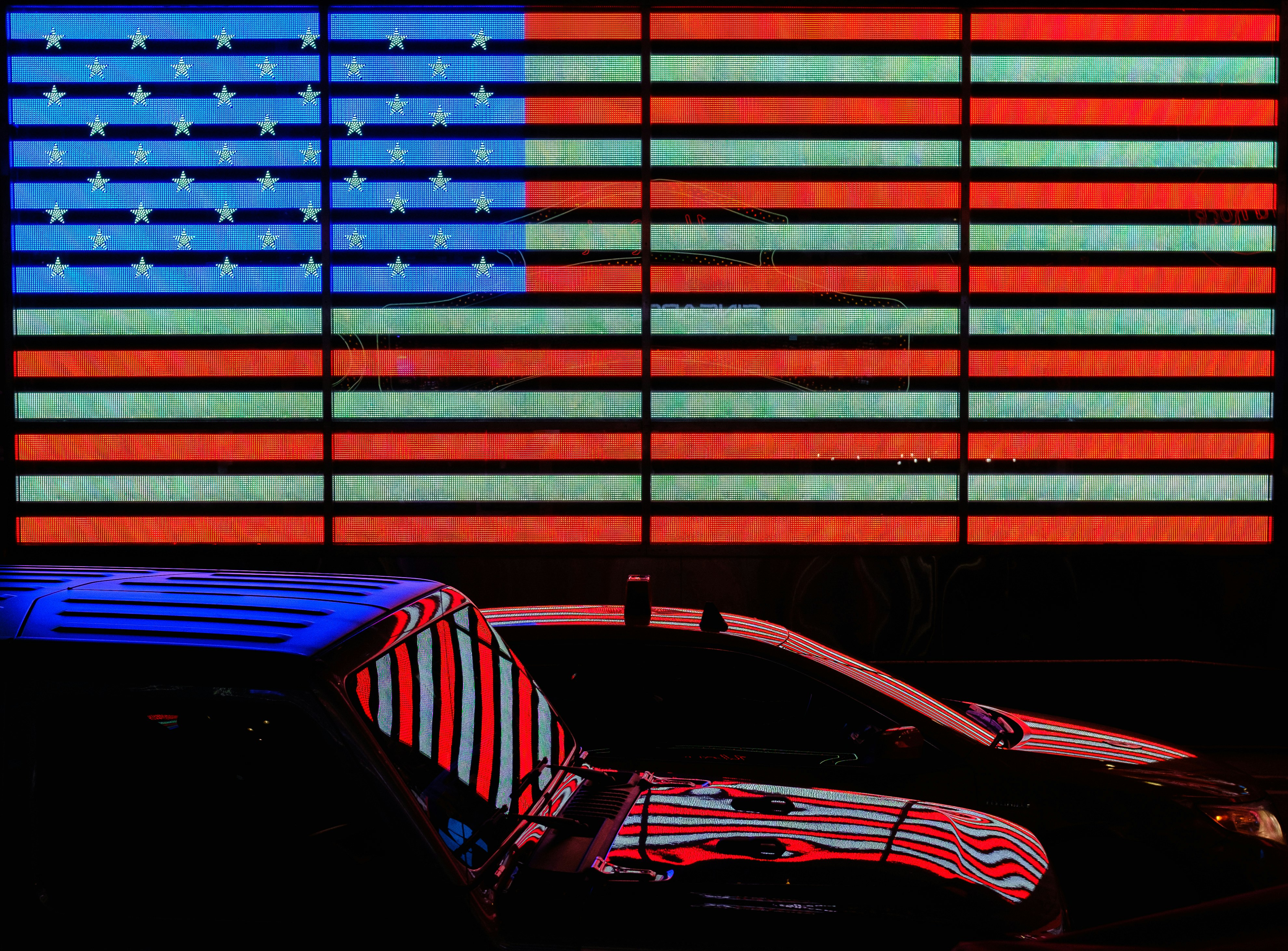 red and blue car in front of blue and red wall
