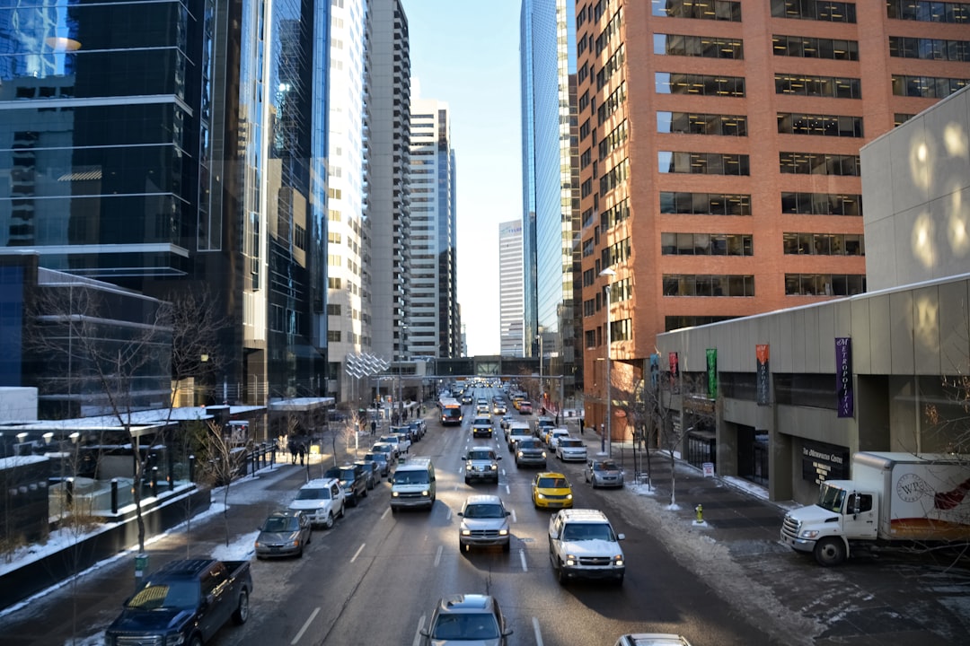 cars on road near high rise buildings during daytime