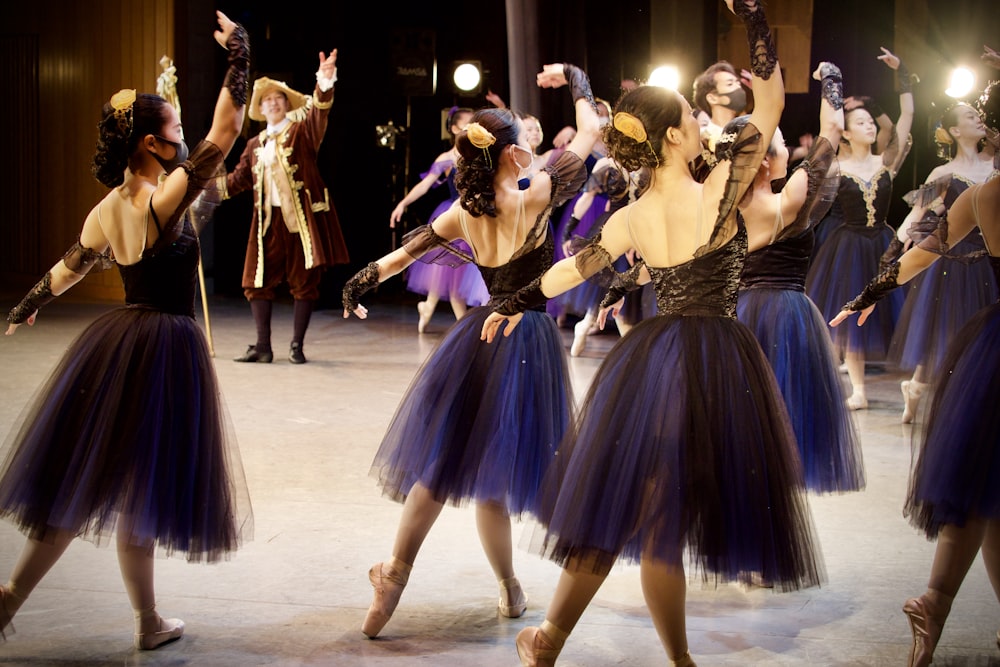 group of women dancing on white floor