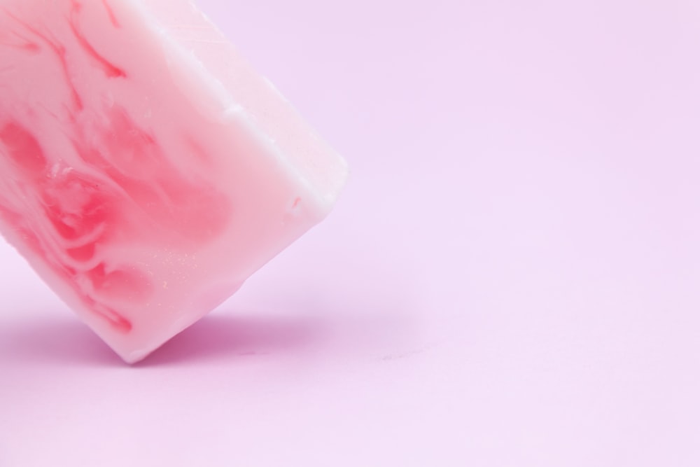 pink plastic container on white surface