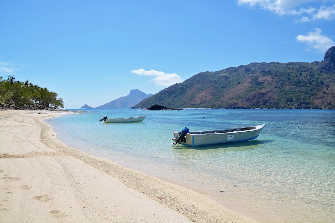 people riding on boat on beach during daytime