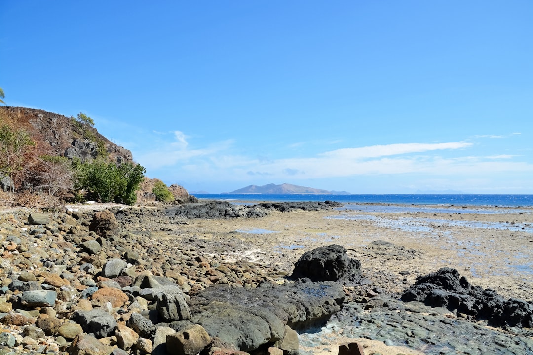 gray rocks on seashore during daytime