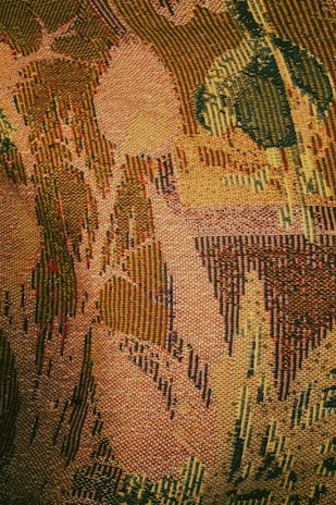 A tapestry mid-weave showing abstract waves and shadows representing the vanished husband’s mysterious departure.