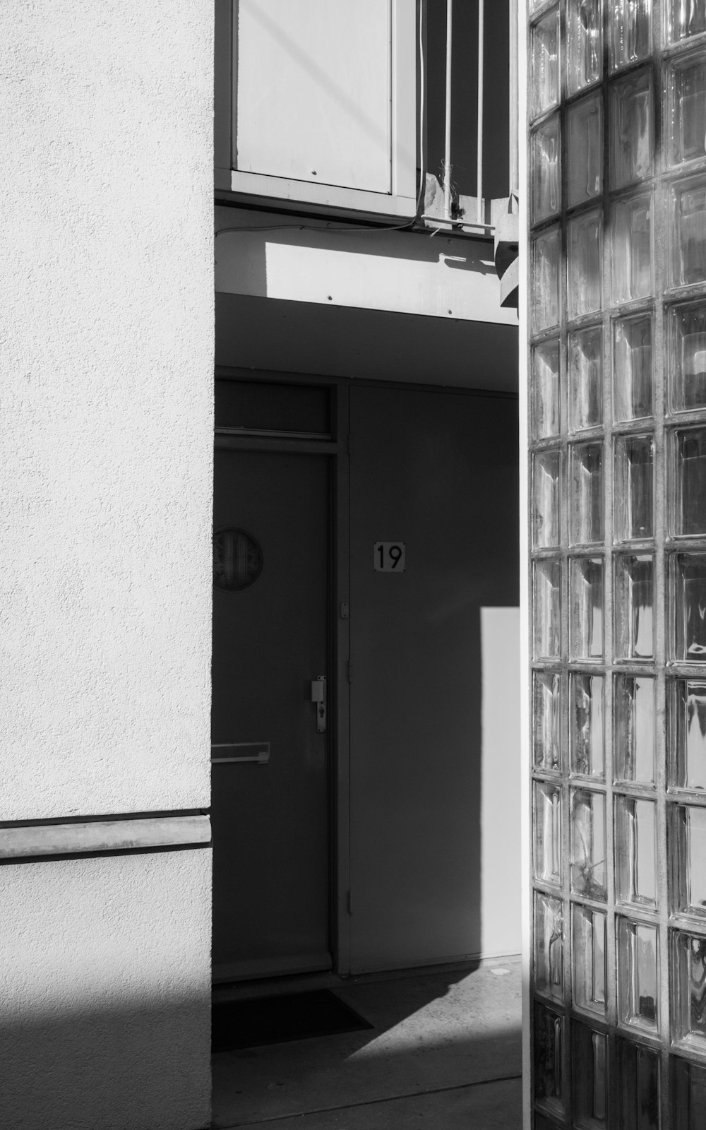 black wooden door beside white wall