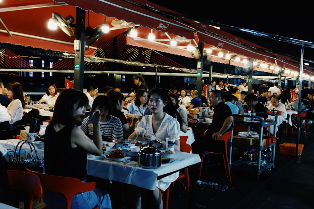 people sitting on chair near table during night time