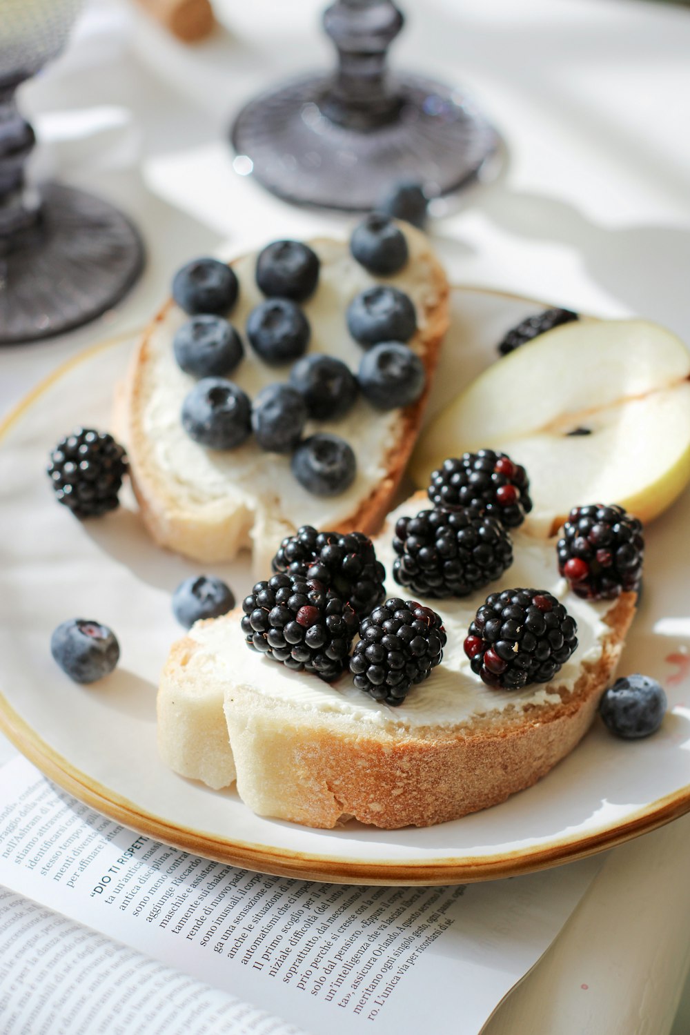 brown and black pastry with blue berries on white ceramic plate