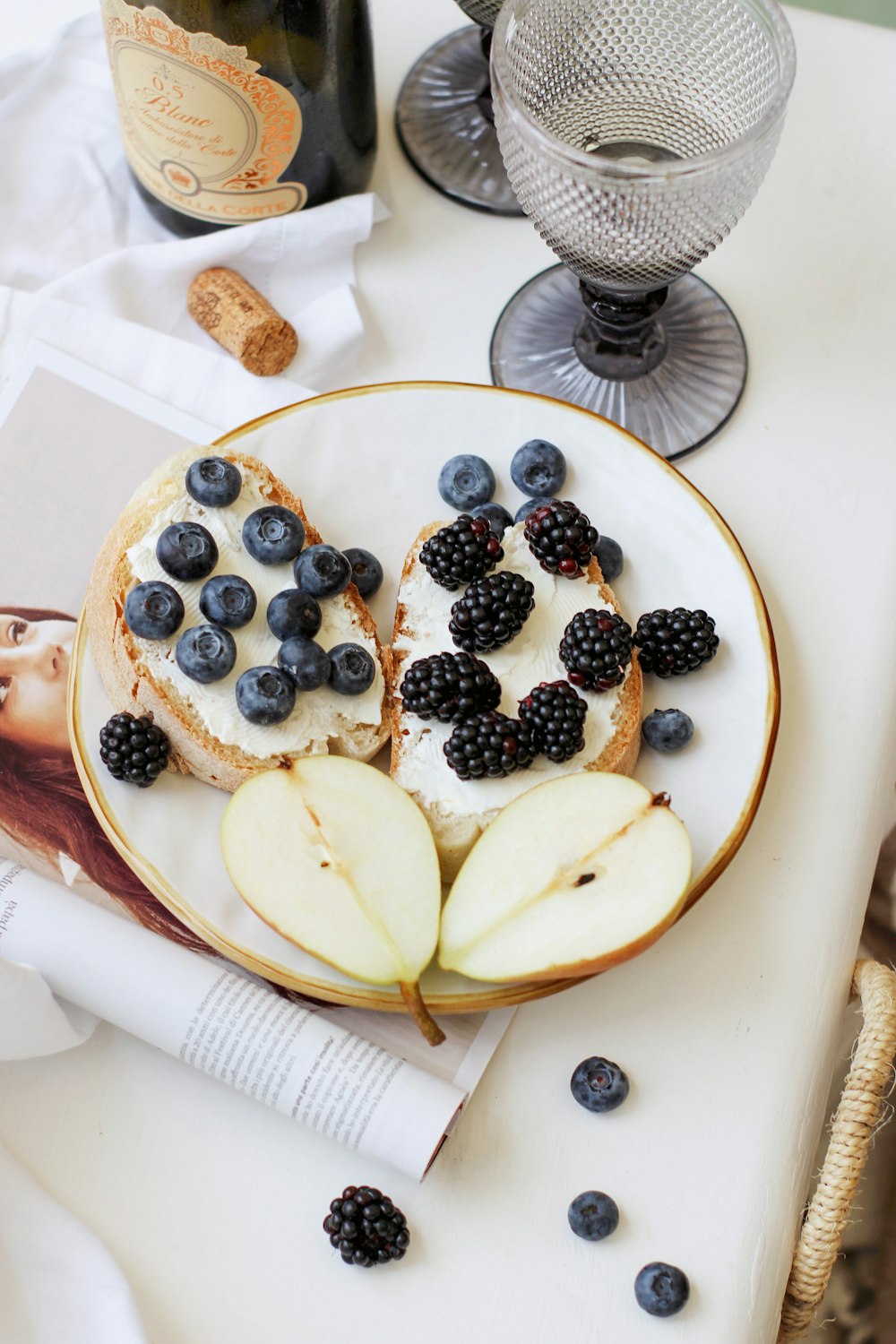 sliced of banana and blue berries on white ceramic plate