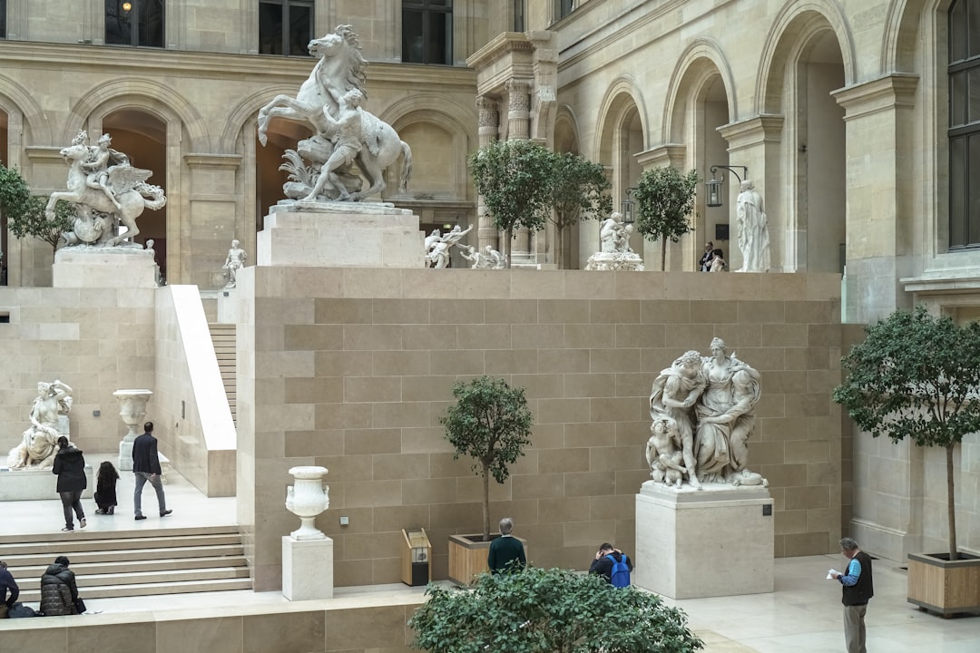 white concrete statue near green plants