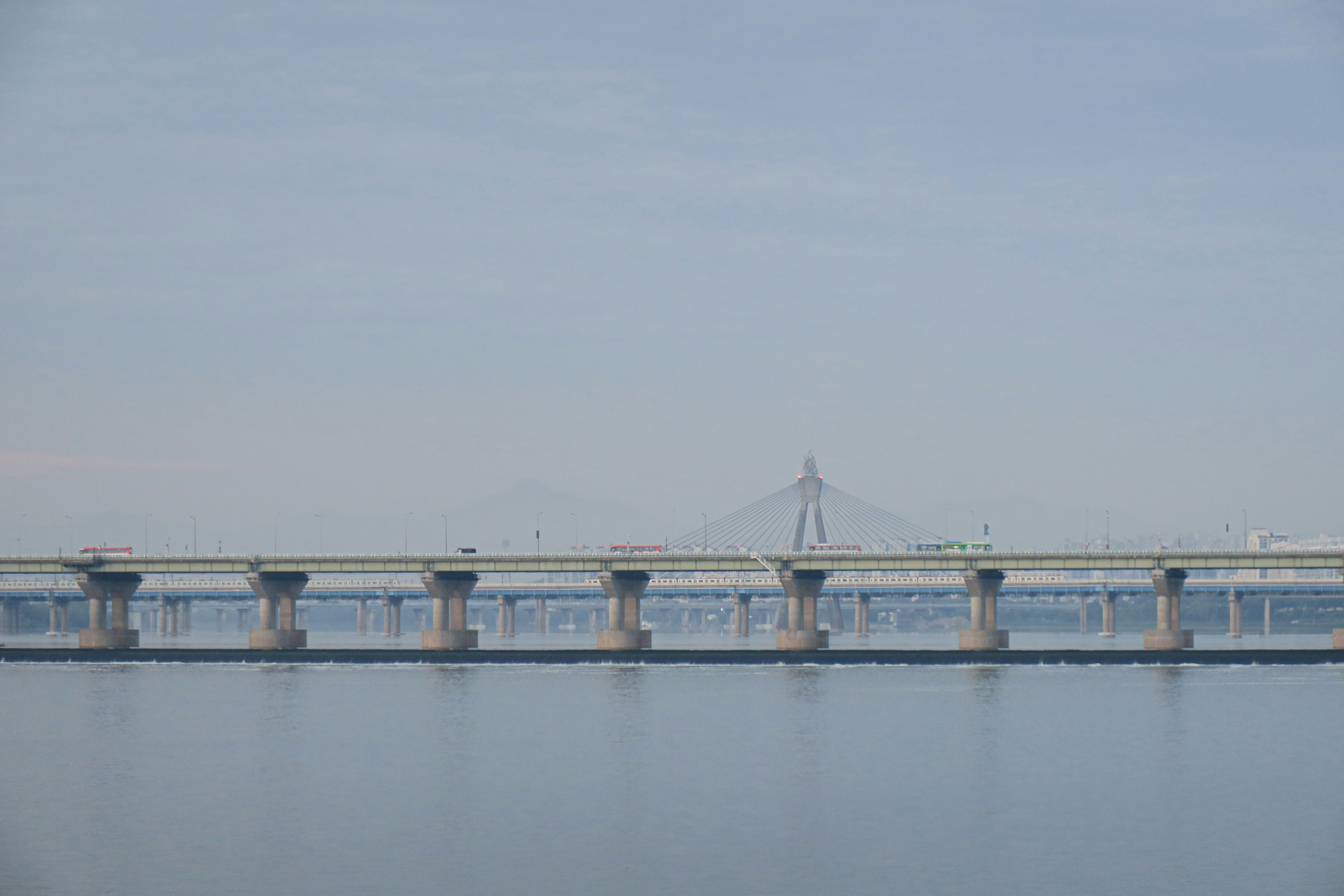 bridge over water under white sky during daytime