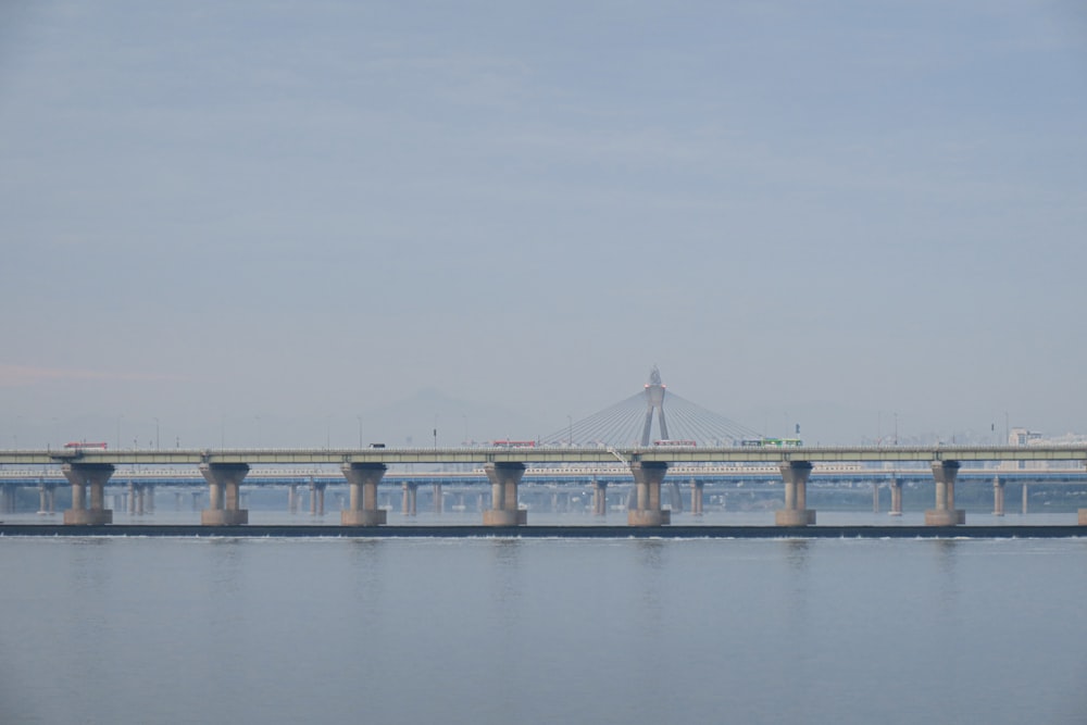 bridge over water under white sky during daytime