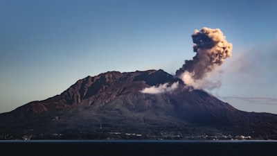 brown and white mountain under blue sky during daytime explosive zoom background