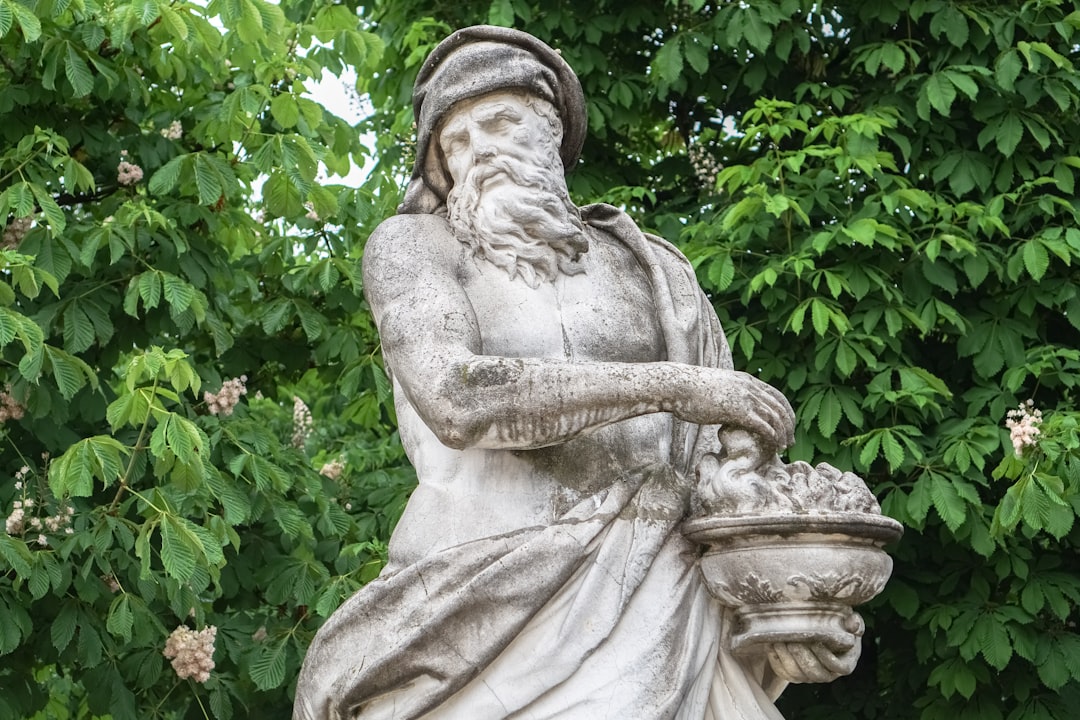 woman statue near green plants