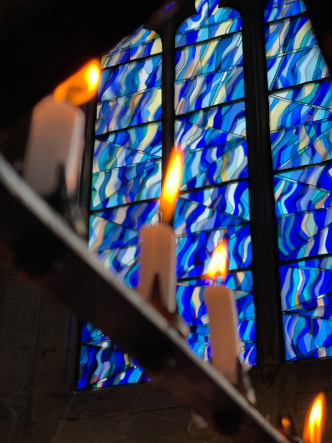 close up photo of candles on black metal frame