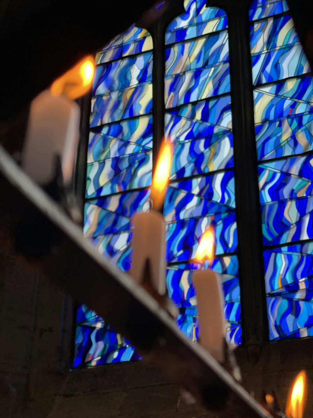 close up photo of candles on black metal frame