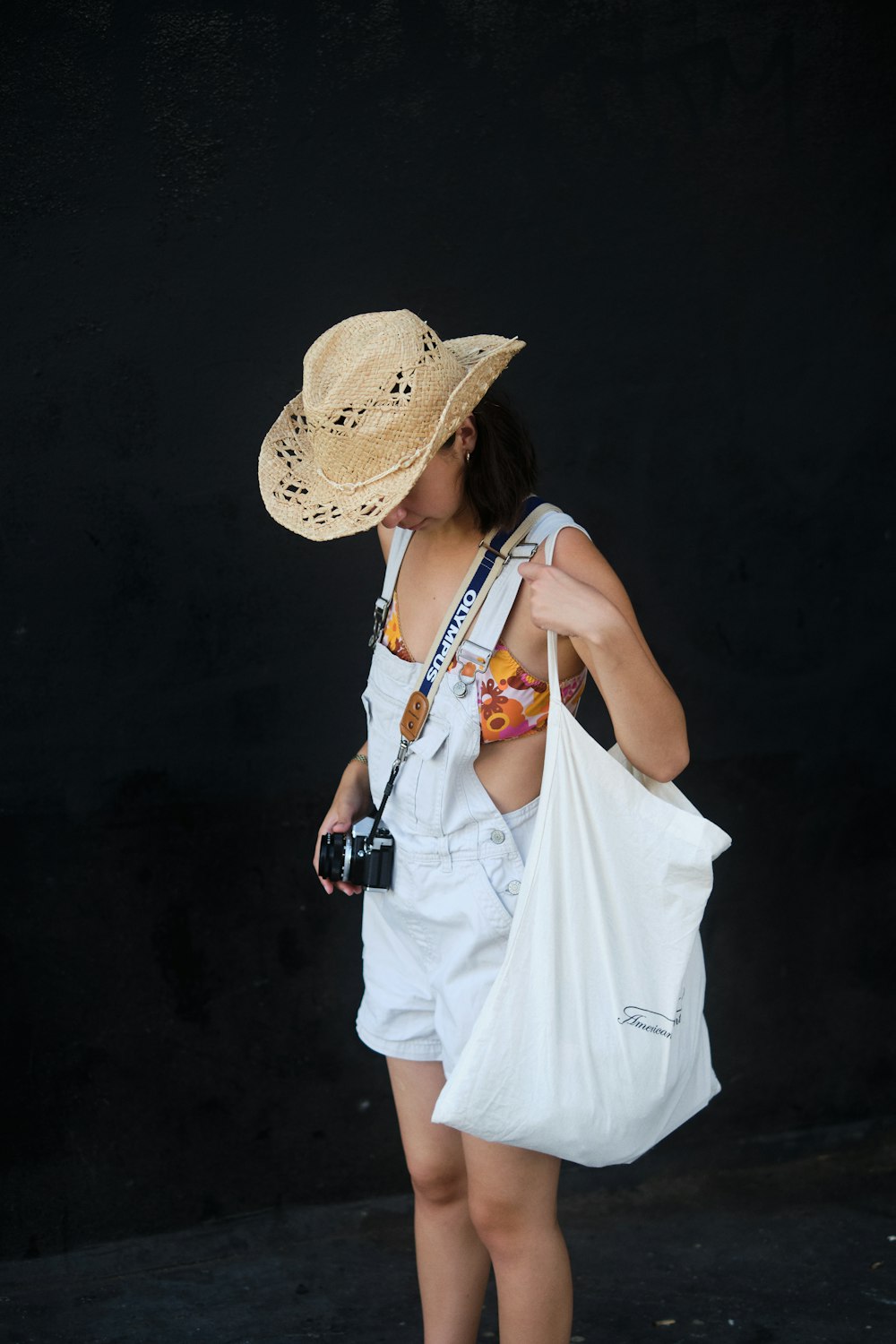 woman in white sleeveless dress wearing brown hat