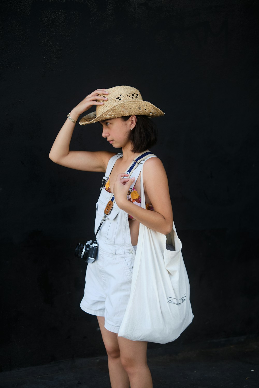 woman in white sleeveless dress wearing brown straw hat