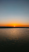 calm sea under orange sky during sunset