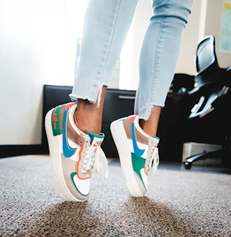 woman in black pants wearing red and black nike sneakers